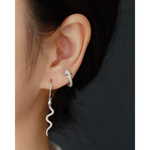 Macro shot of S925 sterling silver snake earrings worn on ear with clear details
