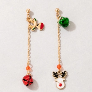 Detail shot of Christmas earrings featuring red bells and white reindeer on gold chains