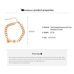Detailed view of golden stainless steel heart and starfish charms on a chunky curb chain