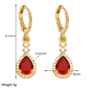 Detail view of gold earrings with red teardrop stone measuring 31mm in height and 9mm wide