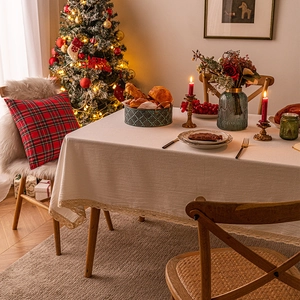 Lace scalloped cream tablecloth in cotton linen on dining table with Christmas tree background