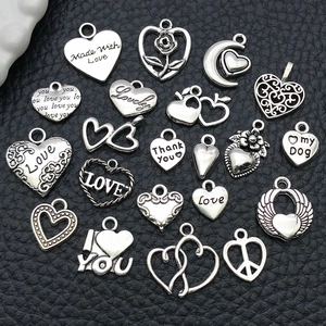 Macro view of assorted vintage silver heart charms for DIY jewelry and necklaces