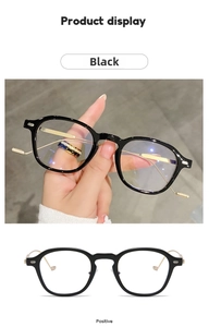 Detailed view of black frame glasses with gold metal temples and anti-blue light lenses