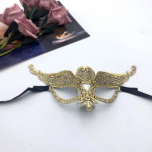 Detailed close-up of golden lace masquerade mask with intricate cutout patterns