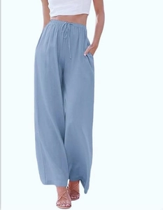 Detail of light blue wide leg pants featuring a high waist drawstring and side pockets