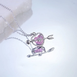 Pink heart-shaped cupid pendant necklace with arrow and silver chain for women