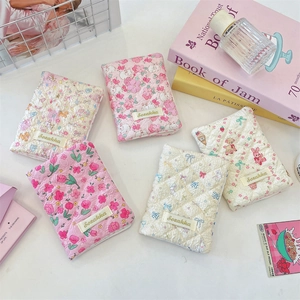 Close-up of cute quilted cotton passport holders with floral and cartoon animal prints