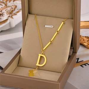 Minimalist 18K gold plated titanium necklace featuring a D-letter pendant in jewelry box