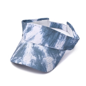 Detailed view of tie-dye sun visor hat with adjustable velcro strap and open top design