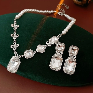Exquisite square floral jewelry set with pearl necklace and rhinestone earrings on velvet