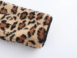 Close-up of leopard print fleece jacket cuffs with black trim and soft texture