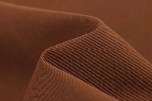 Gros plan sur la texture et les détails tissés du tissu textile bronze profond