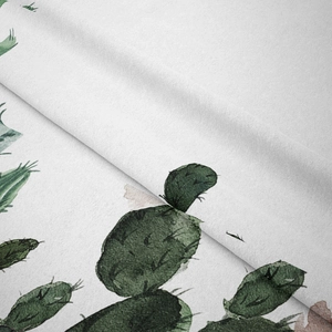 Detailed close-up of cactus print on white twill fabric with soft folding texture
