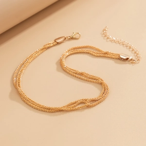 Detail of multi-layered gold wave chain necklace with lobster clasp and extension