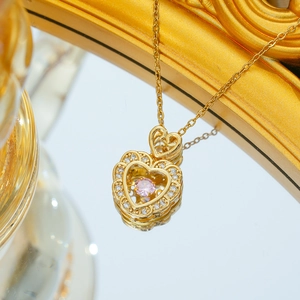 Elegant gold titanium steel necklace with a heart-shaped pink stone and crystal accents