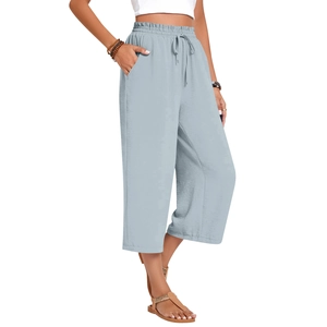 Detail of high waisted light blue linen wide leg trousers with elastic drawstring waist