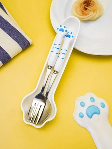 Detail view of 304 stainless steel cat paw fork and spoon set in a portable white storage case