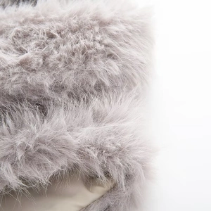Macro detail of high-quality faux fur material showing soft texture and long grey fibers