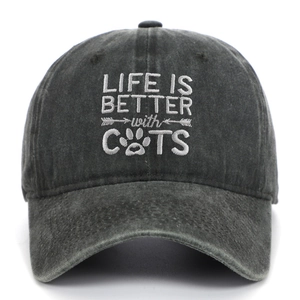 Detail of embroidered Life is Better with Cats text on washed black baseball cap