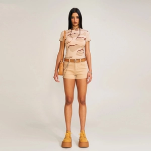Classic high-waist A-line denim shorts in khaki paired with a camo t-shirt and belt