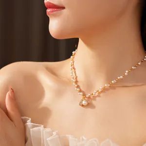 Elegant pearl necklace with gold zircon gourd pendant worn by a model in a side view