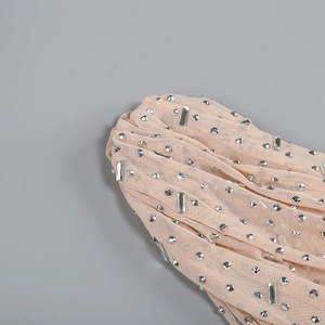 Detailed close-up of pink mesh fabric with embedded silver rhinestones and fine texture