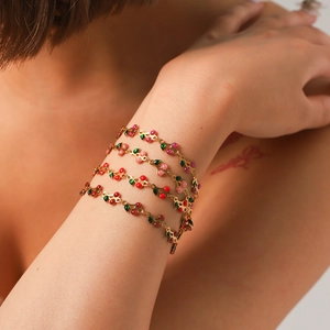 Layered 18K gold plated stainless steel bracelet with red cherry pendants on wrist