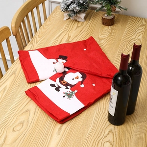 Festive red and white table runner featuring cartoon Santa Claus and snowman patterns