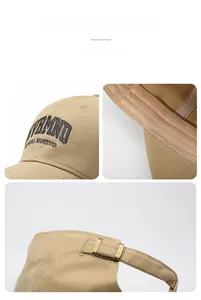 Detailed close-up of embroidered letters and metal buckle on khaki cotton baseball cap