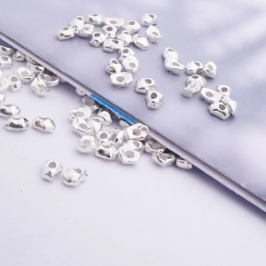 Macro shot of irregular S925 sterling silver loose beads for DIY jewelry making