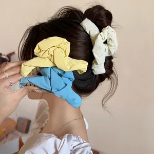 Colorful pleated fabric hair claws for women in yellow, beige and blue floral styles