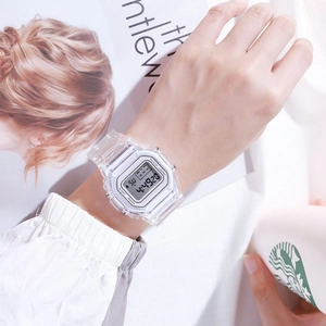 Transparent digital sports watch with LED display worn on wrist in a lifestyle setting