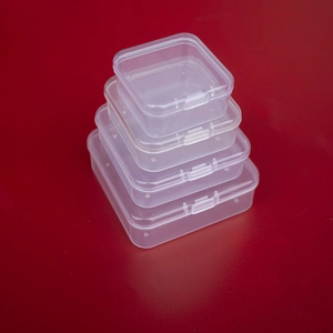 Macro shot showing four sizes of transparent square PP plastic storage boxes with lids