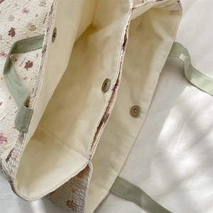 Detail of cute bear floral tote bag with magnetic metal clasp and internal compartment