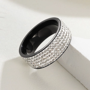 Macro detail of 8mm wide black stainless steel ring with five rows of white zircon pavé