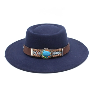 Detail view of ethnic wool felt hat featuring turquoise stone and beaded leather band