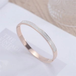 Detail shot of rose gold open bangle with three rows of sparkling zircon pavé