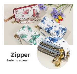 Close-up of dual zipper wristlet wallet featuring butterfly prints and multi-layer storage