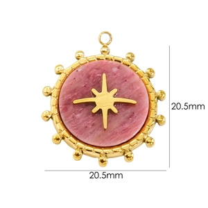 Macro view of a 20.5mm round gold pendant with pink stone and star detail