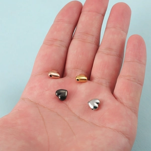 Polished heart-shaped stainless steel pendants in gold, rose gold, silver, and black