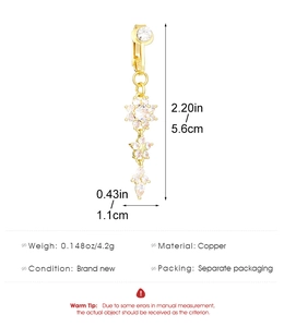 Detail of gold snowflake belly piercing with clear zircons, showing dimensions and copper specs