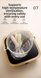 Silicone baby spoons being sterilized in boiling water, showing heat resistance