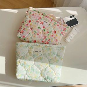 Quilted floral cotton makeup bags in pink and green with soft grid texture