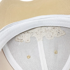 Detail view of khaki baseball cap interior showing Bronx embroidery and cotton stitching