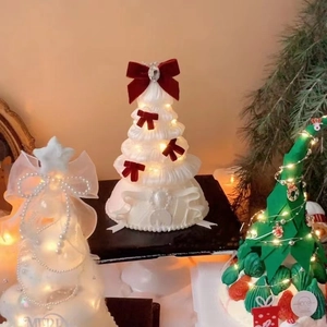 Three DIY Christmas tree table lamps with warm LED lights and elegant ballet-style ribbons
