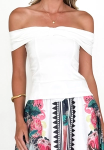 Detail of white off-shoulder slim top paired with rose and leopard print skirt