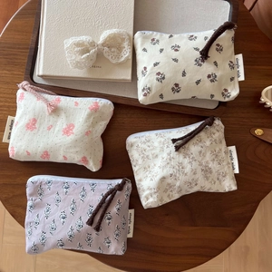 Detailed view of four floral cotton mini pouches with zipper and woven pullers
