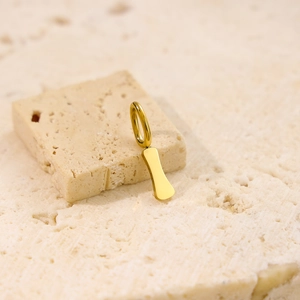 Minimalist gold letter I pendant necklace made of polished stainless steel on stone