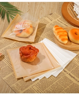 Detail of greaseproof toast bags with Baking Handmade print on vintage newspaper background
