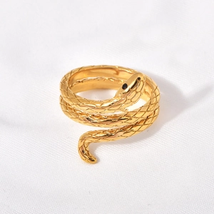 Detailed view of golden snake ring with black gemstones and intricate scale textures
